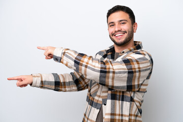 Wall Mural - Young Brazilian man isolated on white background pointing finger to the side and presenting a product