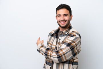 Wall Mural - Young Brazilian man isolated on white background pointing back