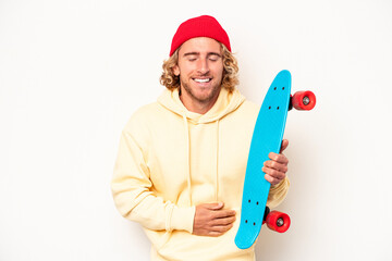 Wall Mural - Young skater caucasian man isolated on white background laughing and having fun.