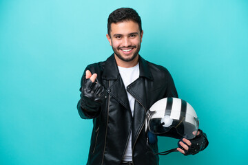 Wall Mural - Young Brazilian woman with a motorcycle helmet isolated on blue background making money gesture