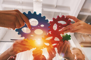 Wall Mural - Business team connect pieces of gears like a teamwork and partners