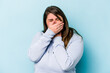 © Asier - Young caucasian overweight woman isolated on blue background suffers pain in throat due a virus or infection.