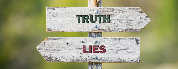 opposite signs on wooden signpost with the text quote truth lies engraved. Web banner format.