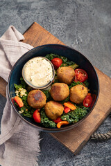 Wall Mural - Falafel with hummus on dark background.