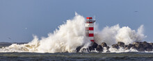 Lighthouse On The South Pier In IJmuiden, Netherlands, Being Struck By Big Breaking Waves Caused By The Storm Dudley In February 2022