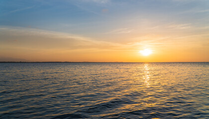 Wall Mural - sunset sky over sea in the evening with orange sunlight clouds