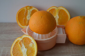 preparation of freshly squeezed orange juice on a hand strainer, 100% fruit juice for a healthy start to the day