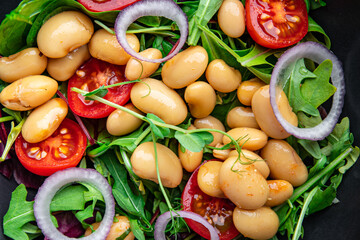  salad white beans, tomato, leaves lettuce mix petals fresh portion healthy meal food diet snack on the table copy space food background keto or paleo diet veggie vegan or vegetarian food no meat