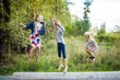 © Cavan Images - Three beautiful young girls jumping, playing outdoors.