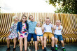 © Cavan Images - Six siblings making funny faces together outdoors.