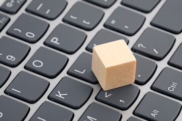 Poster - Wooden block on laptop keyboard
