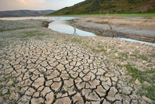 Empty River. Drought Land Texture, Summers Dry, Cracked Soil, Ground On The Field, Blurred Cracked Earth. Global Warming