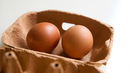 2 eggs resting on the lid of the egg cup