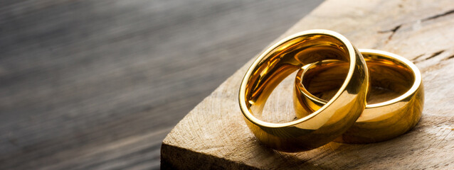 Divorce and separation concept. Two golden wedding rings, judge gavel.