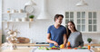 © BestForYou - Young love couple cooking at kitchen.