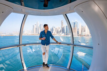 Young Man Enjoying Dubai City View From The Cabin Wheel Of Dubai Ain Or Eye Dubai Ferris Wheel.