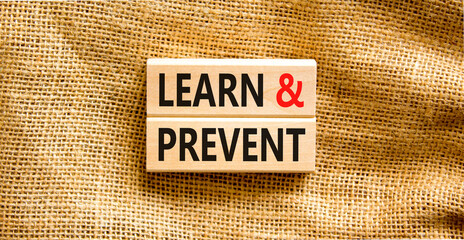 Poster - Learn and prevent symbol. Concept words Learn and prevent on wooden blocks on a beautiful canvas table canvas background. Business learning and learn and prevent concept, copy space.