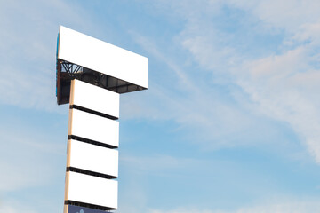 Wall Mural - Mock up image: five blank white billboards or large displays on tower against blue sky. Mockup, white screen, background, consumerism, advertising, template, copyspace concept