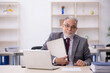 © Elnur - Old male employee working in the office