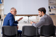 © Elnur - Two male colleagues in business presentation concept