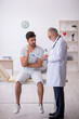 © Elnur - Young male patient visiting old male doctor