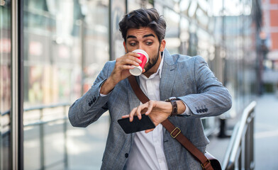 Wall Mural - Never don't be late on business meeting. Worried businessman looking at his watch on the way to office. Business, lifestyle concept