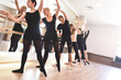 © Nick ALDI - A group of women perform ballet exercises by raising their arms up using the bar at the gym