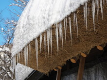 Hida, Japan - February 18, 2022 : Icicle-hung Eaves Of Thatched Roof Or Gassho-zukuri. 

