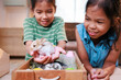 © pingpao - Asian siblings children are playing with baby bunny and decorating easter eggs preparing for Easter at home together with fun. Happy family Happy easter Happy holiday.