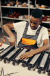 © sata_production - Male factory worker using electric screwdriver