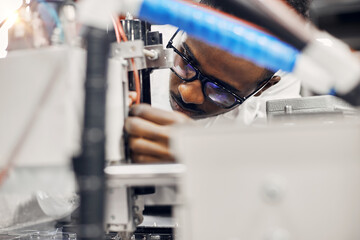 Wall Mural - african engineer programming equipment with tablet at factory