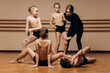 © Кирилл Горшков - Full-length portrait of a beautiful dance teacher instructing a group of little girls in a dance studio, a space for copying