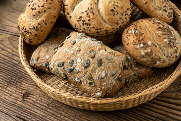 Wall Mural - Wicker basket with selection of breads and pastries. Assortment of baked products