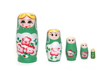 Wall Mural - Green colored nesting dolls on a white background. Russian national souvenir.