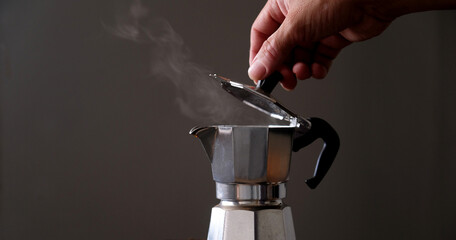 Coffee beans in Moka pot and smoke.