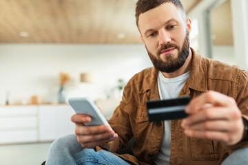 Poster - Bearded Man Shopping Holding Cellphone And Credit Card At Home