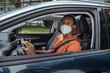 © Westend61 - Man in protective face mask driving car in COVID-19 outbreak