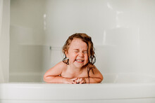 Happy Girl With Eyes Closed In Bathtub
