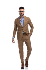 Wall Mural - full body picture of bearded man in brown suit holding hand in pocket