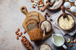 Keto bread cooking. Different types of nut flour - almond, hazelnut, cashew and baking ingredients, dark background.