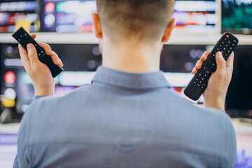 Man holding two different remote control