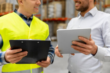 Poster - wholesale, logistic business and people concept - close up of warehouse worker and businessman with clipboard and tablet pc computer