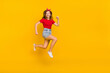 © deagreez - Full size photo of impressed teen girl run wear t-shirt hairband skirt footwear isolated on yellow background