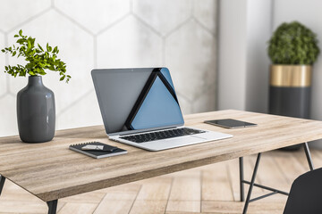 Aufkleber - Sunny stylish home workspace with eco interior design: grey glossy clay pot with flowers, laptop, smartphone and digital tablet on natural wooden table and wooden floor, close up. 3D rendering