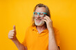 © Tatiana - Senior grey-haired man gray beard communication on the phone emotions yellow background