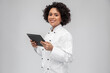 © Syda Productions - cooking, culinary and people concept - happy smiling female chef in white jacket with tablet pc computer over grey background