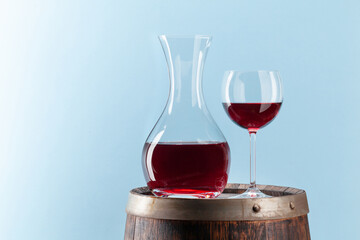 Wall Mural - Decanter with red wine on old wooden barrel