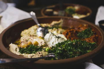 Wall Mural - Assorted Middle Eastern dishes including hummus, baba ghanoush, tabbouleh, salad. Oriental appetizer on rusty plates