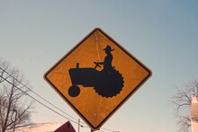 Tractor Crossing Sign With Blue Sky In Winter