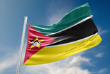 Fototapeta  - Mozambique Flag is Waving Against Blue Sky
